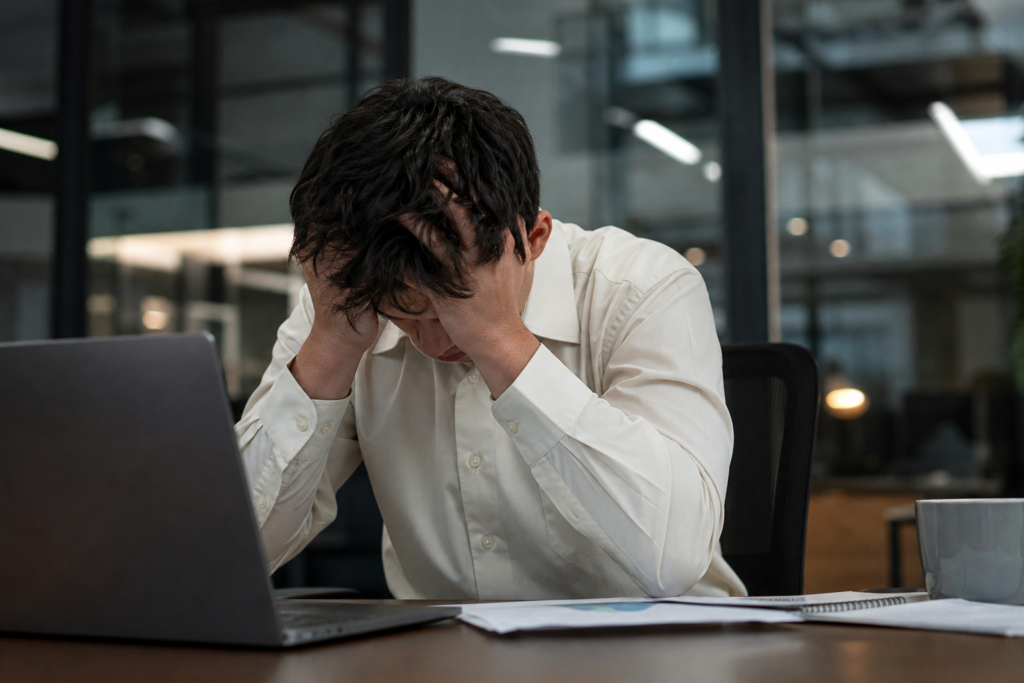Cena de escritório onde um empregado parece estressado, simbolizando burnout e assédio moral